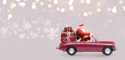 Santa Claus on car delivering Christmas or New Year gifts at snowy gray background