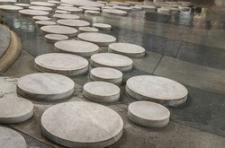 Sidewalk paved with round stone, rock or concrete slabs of various sizes for landscape by paving in outdoor to create pavement floor, path, walkway or pathway.