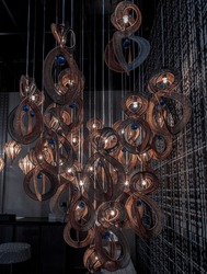 Softly shining hanged lamps with Braided Colorful Ropes, which means in Chinese Lucky Number Eight with dark background. Beautiful decor for the interior, 8 infinity unlimited lucky signs concept,