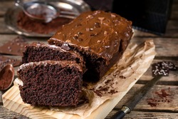 Moist chocolate cake with milk chocolate topping glaze and cocoa powder