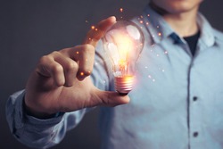 Man holding light bulbs, ideas of new ideas beautiful creative and communicate the new inventions with innovative technology and creativity. concept creativity with bulbs that shine glitter