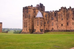 Cloudy day and green field at Alnwick Castle, Northumberland, United Kingdom