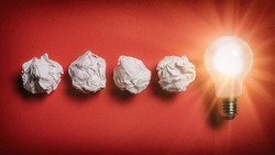 Problem solving concept - crumpled paper turns into glowing lightbulb