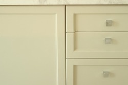 White or natural beige drawer and shelves for storing various miscellaneous items in the modern house living apartment. Close up cabinet built in and free space for wallpaper background cover page.
