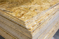 OSB - Oriented strand board. Stacked OSB sheets. Sheet material for the construction of frame houses
