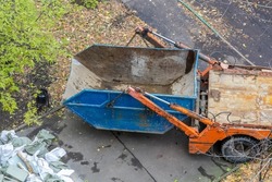 Truck with detachable dumpster. Removal of construction debris by car. Dumpster. Cleaning the city of construction debris. Large garbage container