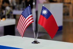 Two table flags of the USA and Taiwan together at some event or fair, as a symbol of cooperation between the two states. Joint business of the United States of America and the Republic of China