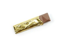 Chocolate bar in opened gold aluminum foil isolated on white background