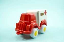 red paint plastic toy ambulance car isolated on blue background