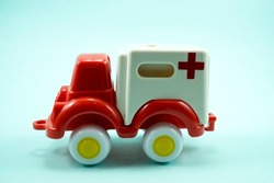 red paint plastic toy ambulance car isolated on blue background