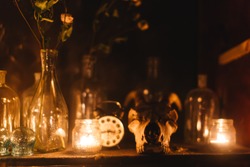 Shelf of alchemist jars of medicine potions skull goat skull. Ancient mystery magic mystic occult ritual. Candles old antique witch scary halloween witcher sorcerer wizard spiritism texture 
