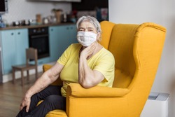 senior old woman in mask quarantine europe. Elderly at risk for coronavirus covid-19. Stay at home. Chinese virus pneumonia pandemic protection grandmother. danger of getting infected