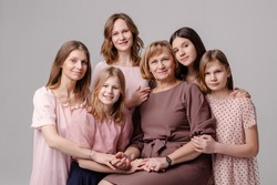 Woman's wife 8 march concept. Large family of women of different ages hugging portrait. Femininity support caring. Several female generations. Maternity is sisterhood feminism. Grandmother