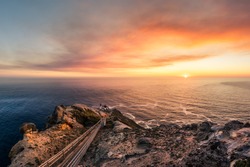 Wonderful sunset over the ocean at Point Reyes Lighthouse near San Francisco California. Path to the lighthouse. Sunset over the water with lighthouse. Landscape photo with sunset.
