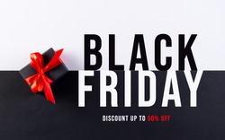 Black Friday. Top view of black christmas boxes with red ribbon on black and white paper background with copy space for text.