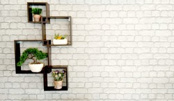 
Wooden shelf Attached to the plaster wall There are flowers and little tree placed on the floor of shelf, looks beautiful. Make the house more pleasant,interior concept.