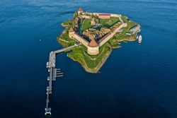 Aerial photography of the Oreshek Fortress in Shlisselburg in summer in Lake Ladoga. Top view of Walnut Island with a fortress. Russia, Shlisselburg, 08.21.2021.