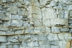 Fragment of natural limestone cliff in Kesselaid (also Kessulaid) islet nordic coast. Tiny island in Suur Strait, Baltic Sea Layers of cracked rocks. Texture of  hard sedimentary rock. Estonian coast.