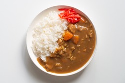 Japanese ordinary curry rice in white dish on white wooden background