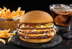 Smash burger with fries in black backgraund