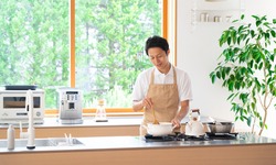 Asian man cooking with an apron