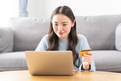 Young Asian woman using a credit card