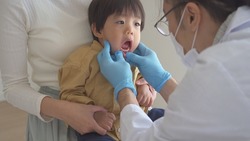 A dentist examining the baby's mouth