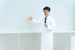 Japanese man working in the medical field holding a microphone and talking