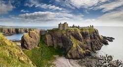 Panorama of Dunnottar Castle Medieval clifftop ruins from cliff above rocks of Old Hall Bay North Sea near Stonehaven Scotland UK