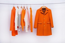 female, colorful coat ,jacket, suit with , sweater with shirt an dress ,coat on hanger