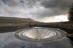 Wide angle view of the overflow plug hole at Ladybower reservoir. In high waters during winter water is allowed to escape cascading down into the river below. Yorkshire Bridge, Peak District, England