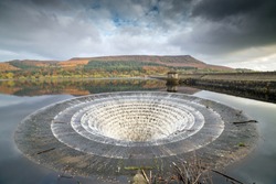 Wide angle view of the overflow plug hole at Ladybower reservoir. In high waters during winter water is allowed to escape cascading down into the river below. Yorkshire Bridge, Peak District, England