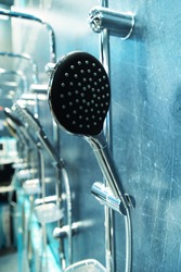 Shower head in a shop window. Modern plumbing trade. Vertical photo. Close-up