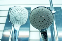 Large shower heads in a shop window. Comparison and selection of bathroom equipment. Close-up