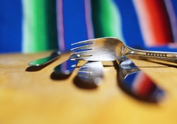beautiful old cutlery set, dessert fork and knives on the colourful background