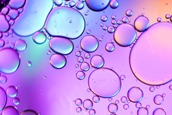 Colorful artistic of oil drop floating on the water. Abstract Purple water bubbles background. holiday light background. holiday postcard background. oil drops on the water surface