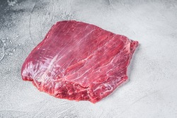 Raw flank or flap beef meat steak. White background. Top view