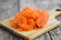 Grated carrot on a wooden background