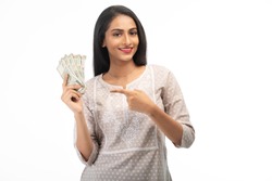 Attractive Indian Woman Pointing to Money, Against a White Background