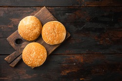 Hamburger bread Homemade Brioche Hamburger Buns set, on wooden serving board, on old dark  wooden table background, top view flat lay, with copy space for text