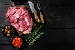 Fresh and raw meat Lamb or mutton set, with ingredients and herbs, on black wooden table background, top view flat lay, with copy space for text