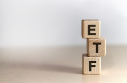 ETF - Exchange Traded Fund text on wooden cubes, on white background
