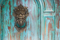 Door knocker with demon face . Copy space 