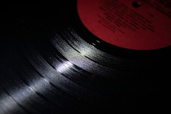 Close-up of abstraction, old vinyl records. Music of the last century. Photo of a selective focus vinyl record. Retro wallpaper.