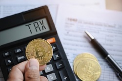Bitcoin taxation or cryptocurrency concept with US tax form 1040 in Individual Income Tax Return.