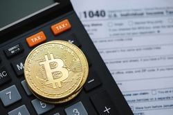 Bitcoin taxation or cryptocurrency concept with US tax form 1040 in Individual Income Tax Return.