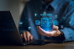 Businessman using a computer and blockchain icon in hand  to Blockchain technology concept with a chain of encrypted blocks to secure cryptocurrencies and bitcoin for online payments 
