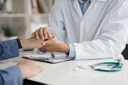Doctor or psychiatrist shakes hands encouragement the patient and care having a consultation on diagnostic examination on male disease or mental illness in a clinic or hospital mental health service 