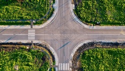  Aerial shot of a flat automobile intersection.  A flat road with markings. View from the height of the highway
