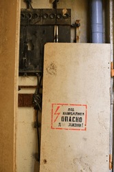 Russian words on a broken fuse box, translation : Voltage - danger to life!